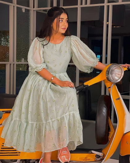 Areeka Haq posing for a photo with scooter 