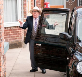 Malcolm Hebden standing outside his car 