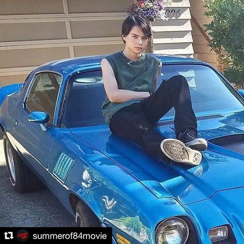 Judah Lewis posing for a photo with his car