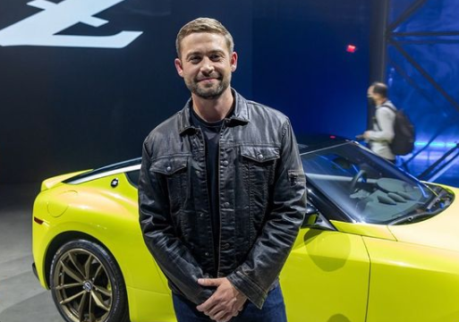 Cody Walker posing for a photo with his car
