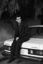 Kalama Epstein posing for a photo with his car 