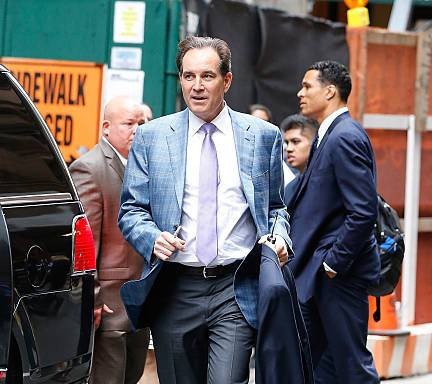 Jim Nantz standing outside his car