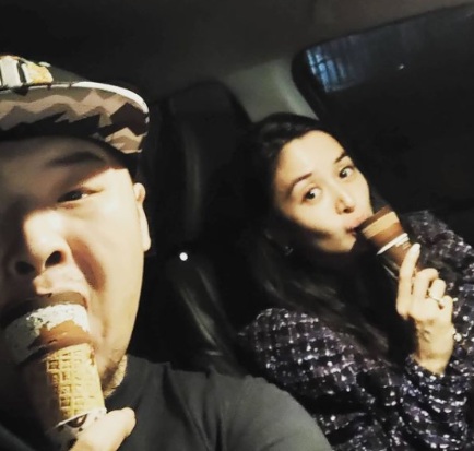 Perry Choi and his wife, Kris Bernal posing inside his car