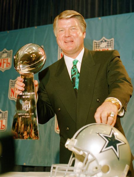 Jimmy Johnson posing for a photo with award