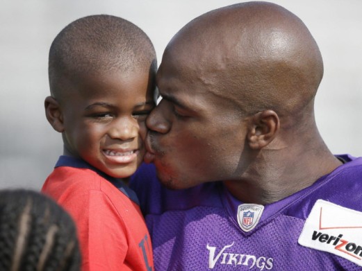 Adrian Peterson with his son