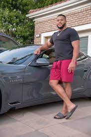  Aaron Donald posing for a photo with his car 