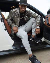 Francisco Lindor posing for a photo with his car