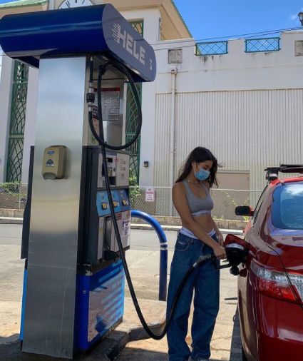 Kirsten Titus with her car at petrol station
