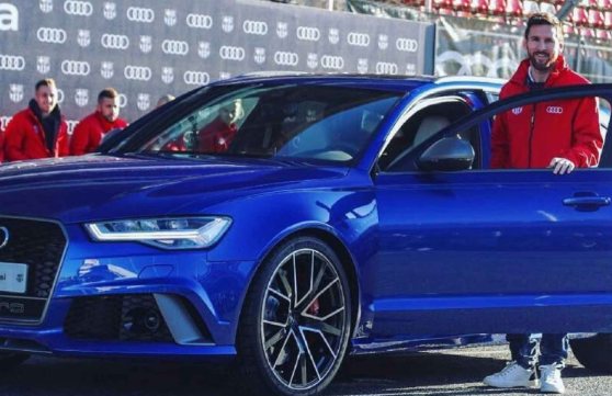 Lionel Messi posing with his car