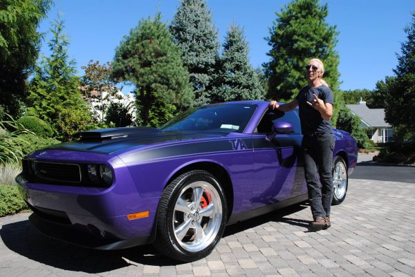 Dee Snider posing for a photo with his car