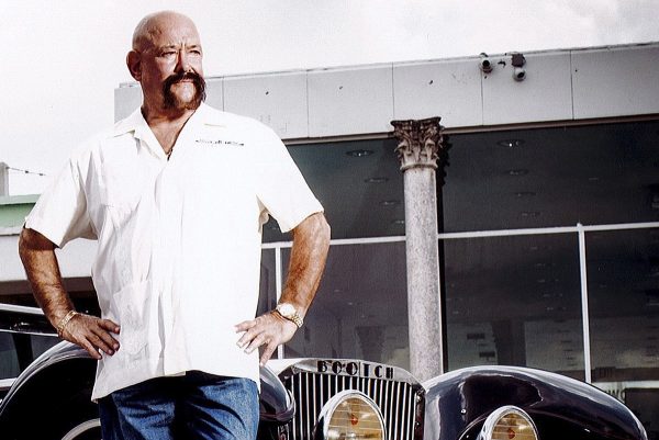 Ted Vernon posing for a photo with his car