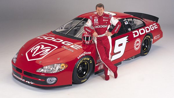 Bill Elliott posing for a photo with his car