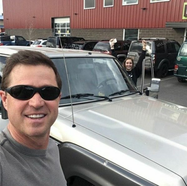 Eric Close posing for a photo with his car