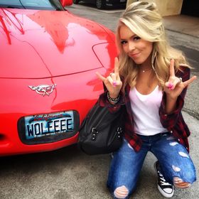 Colleen Wolfe posing for a photo with her car 