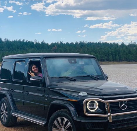 Ameerah Navalua posing with her car