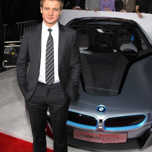Jeremy Renner posing infront of brand new BMW