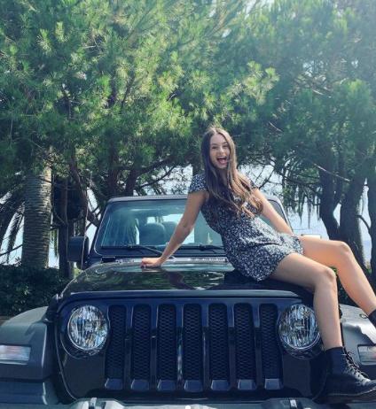 Jaime Adler posing with her jeep