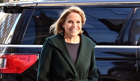Katie Couric posing with her car