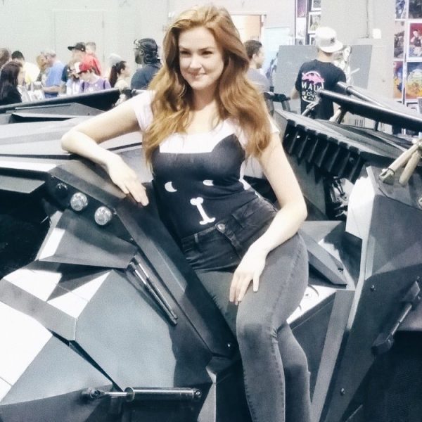 Maggie Geha posing for a photo with her car