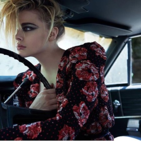 Chloe posing inside her Car
