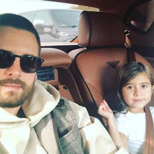 Penelope posing wit her father inside car
