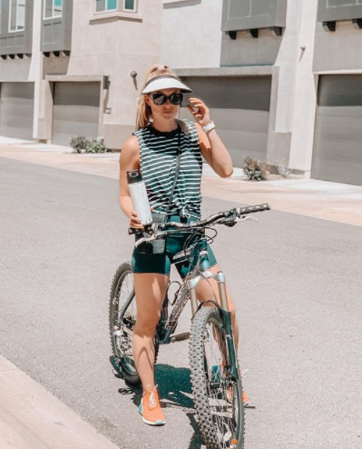 Erica Weston posing for a photo with her bicycle