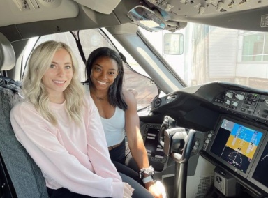 Simone Biles sitting inside the car with her friend