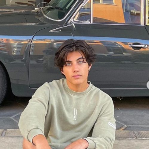 Nic Kaufmann posing in front car