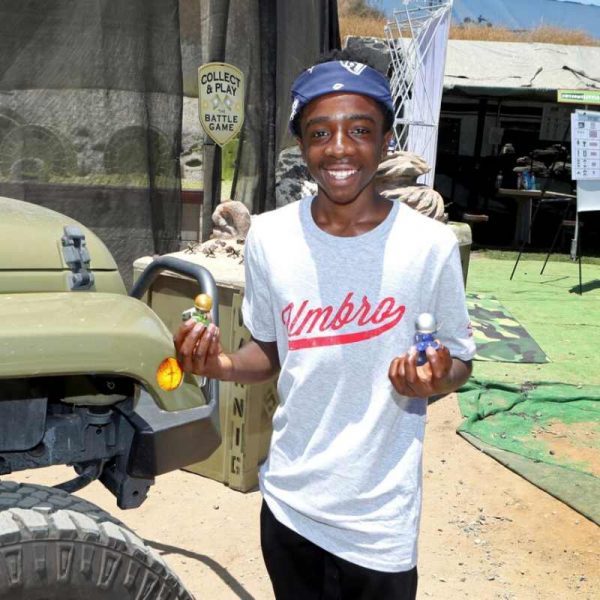 Caleb McLaughlin posing for a photo with his car