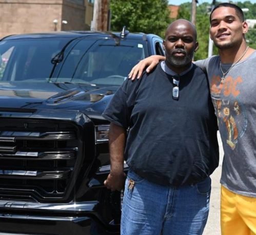 james conner posing in front of car with father