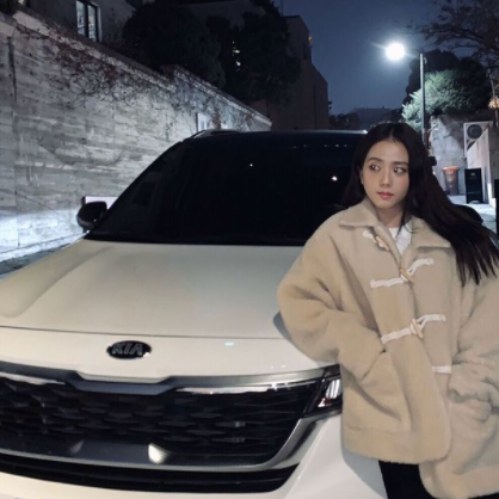 Jisoo Kim posing in front of car
