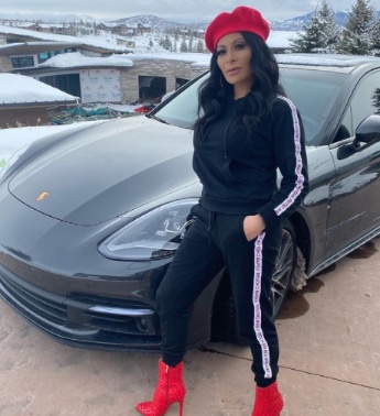 Jen Shah posing for a photo with her car