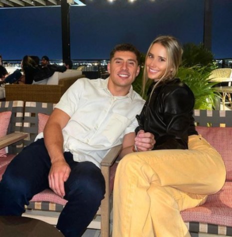 Kendall Moore posing with her boyfriend, Ian Book