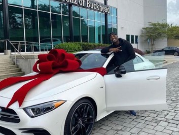 Hitman Holla posing for a photo with his car