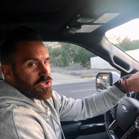 Chanel Weddie's husband, Eric Weddle posing in car