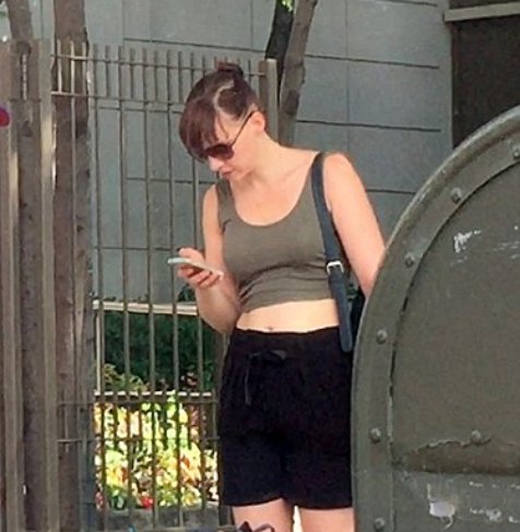 Erin Darke posing in front of her house gate