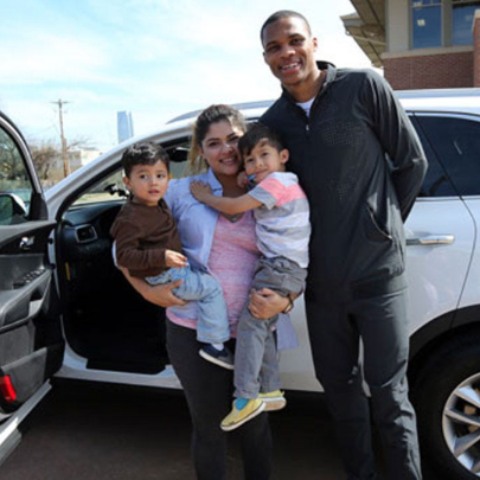 Sky Westbrook's family posing with car