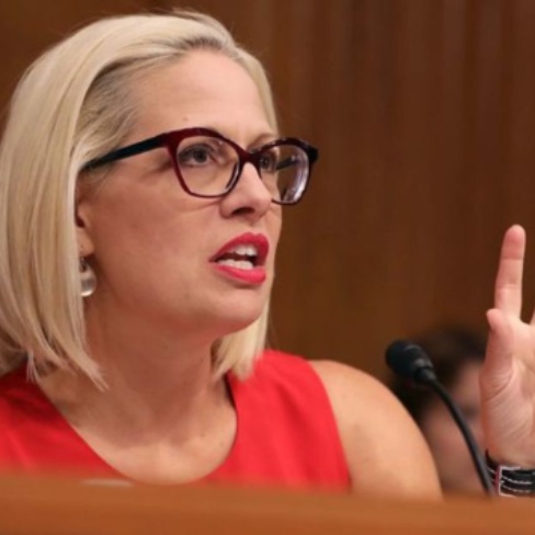 Blake Dain's ex- wife, Krysten Sinema in between her speech 