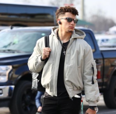 Patrick Mahomes posing with car