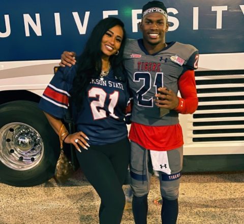 Pilar Sanders with her son in front of the bus