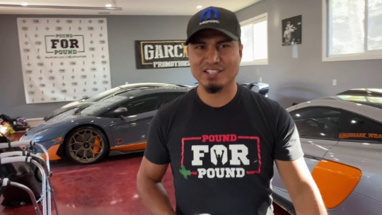 Mikey Garcia posing in front of the car