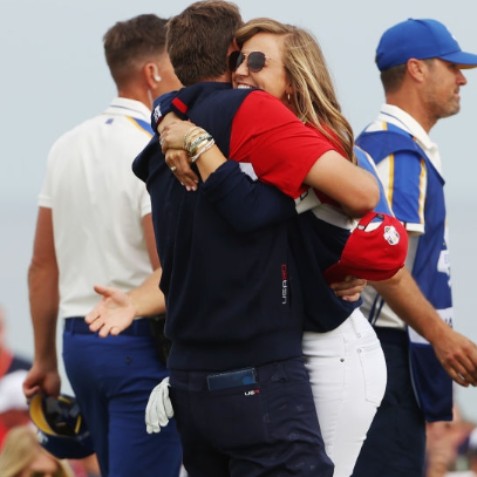 Meredith Scudder cheering her husbnad in field