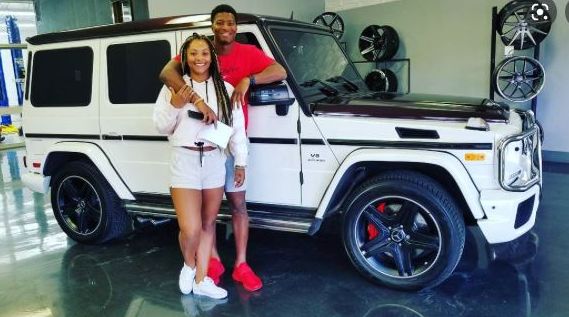 Breion Nicole Allen and her husband with their car