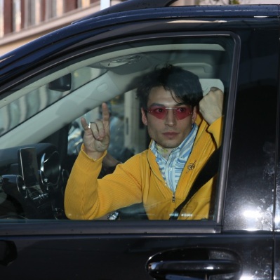 Ezra Miller posing inside the car