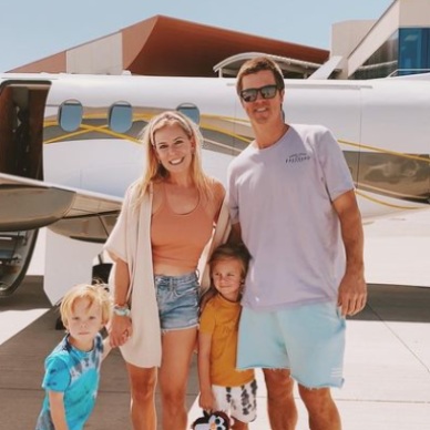 Emily Grienke picture infront of the jet with family 