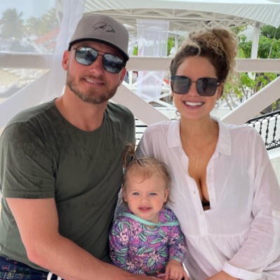 Briana Miller posing with her partner, Josh Donaldson and child 