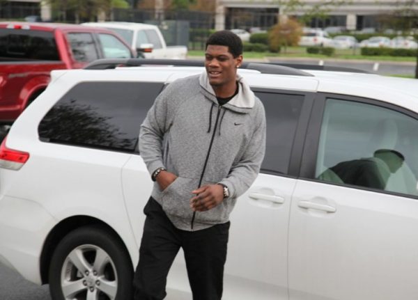Randy Gregory posing for a photo with his car 