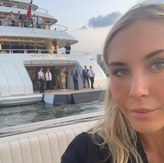 Alexandra Long taking pictures in front of the Yacht 