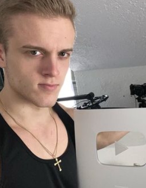 Joe Bartolozzi posing with his YouTube Play Button