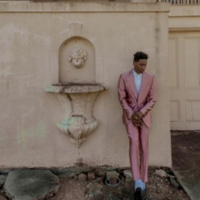 Jon Batiste infront of the house